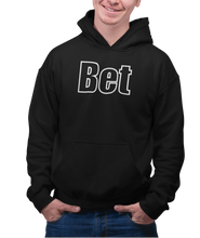 Load image into Gallery viewer, The design is the word Bet, written in black lettering with a white outline. Printed on a classic black hoodie.