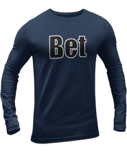 Load image into Gallery viewer, The design is the word Bet, written in black lettering with a white outline. Printed on a navy long sleeve shirt by Bella+Canvas.