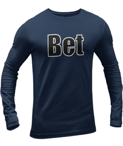 The design is the word Bet, written in black lettering with a white outline. Printed on a navy long sleeve shirt by Bella+Canvas.