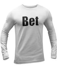 Load image into Gallery viewer, The design is the word Bet, written in black lettering with a white outline. Printed on a white long sleeve shirt by Bella+Canvas.