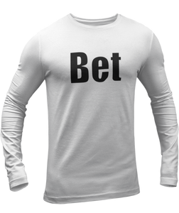 The design is the word Bet, written in black lettering with a white outline. Printed on a white long sleeve shirt by Bella+Canvas.