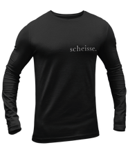 Load image into Gallery viewer, The design is the word scheisse. in white lettering. The design is printed on left side of this black long sleeve shirt.