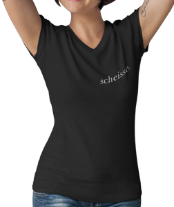 The design is the word scheisse. in white lettering. The design is printed on left side of this black v-neck ladies tee.