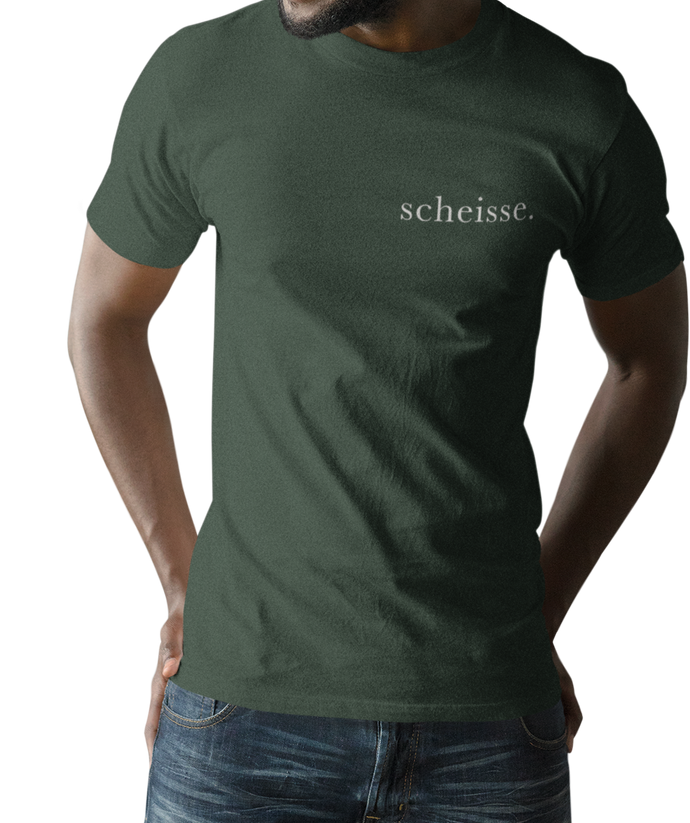 The design is the word scheisse. in white lettering. The design is printed on left side of this forest green simply great tee.