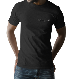 The design is the word scheisse. in white lettering. The design is printed on left side of this black simply great tee.