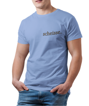 Load image into Gallery viewer, The design is the word scheisse. in brown lettering. The design is printed on the left side of the carolina blue tee.