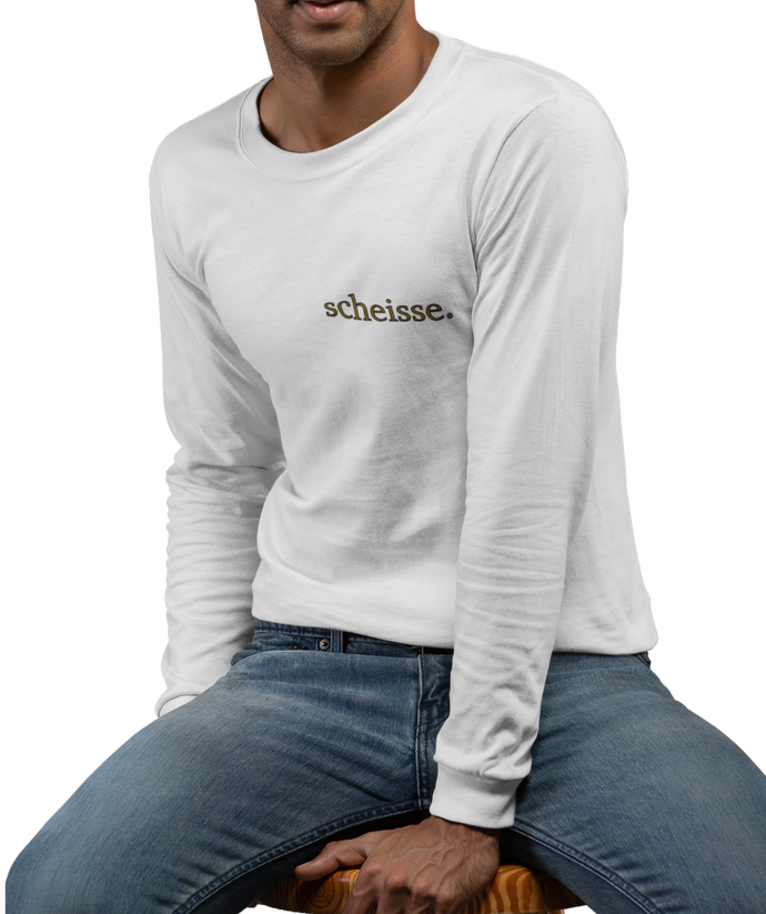 The design is the word scheisse. written in brown lettering. This design is printed over the left breast on a white long sleeve shirt.