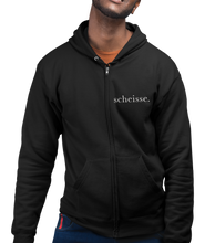 Load image into Gallery viewer, The design is the word scheisse. written in white lettering. The design is on the left side of the zipper on this black hoodie.